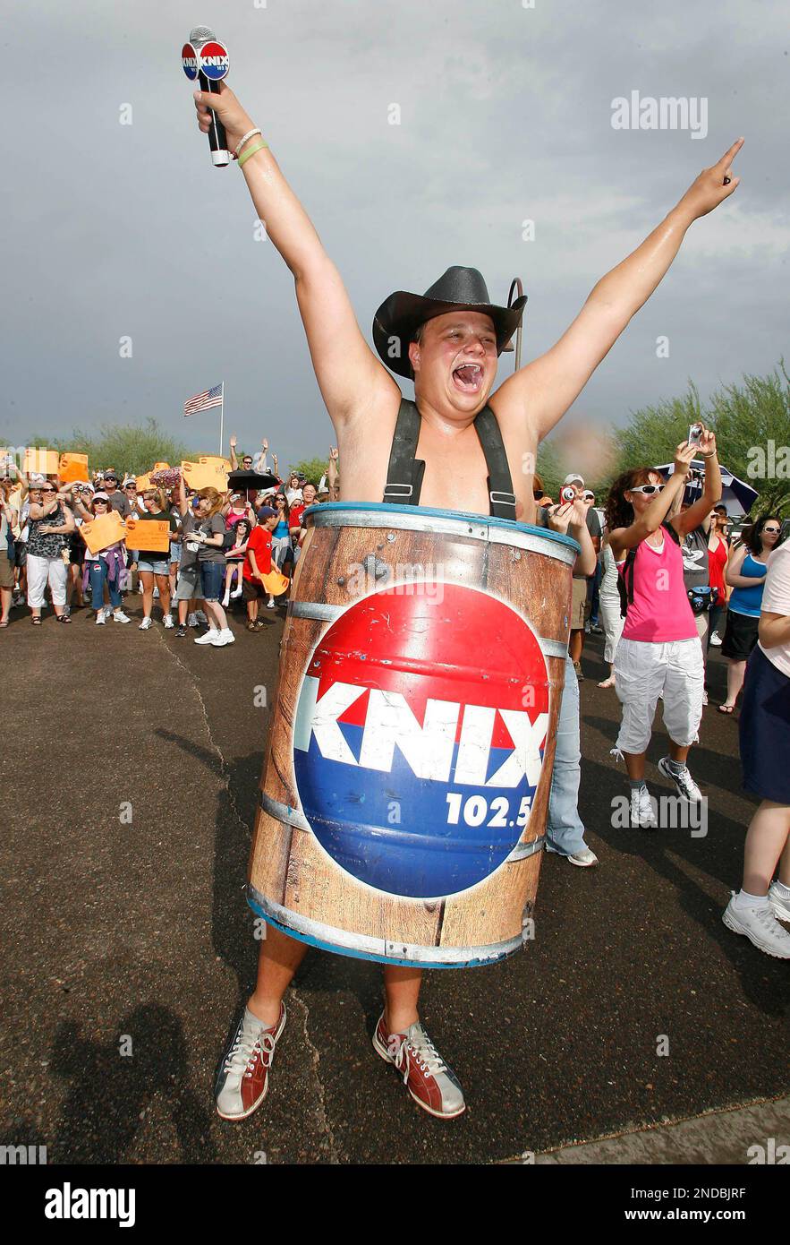 KNIX FM 102.5 radio personality Barrel Boy and a large crowd cheer on  country music recording artist Jimmy Wayne as he makes his way to Steele  Indian School Park in Phoenix, Ariz.