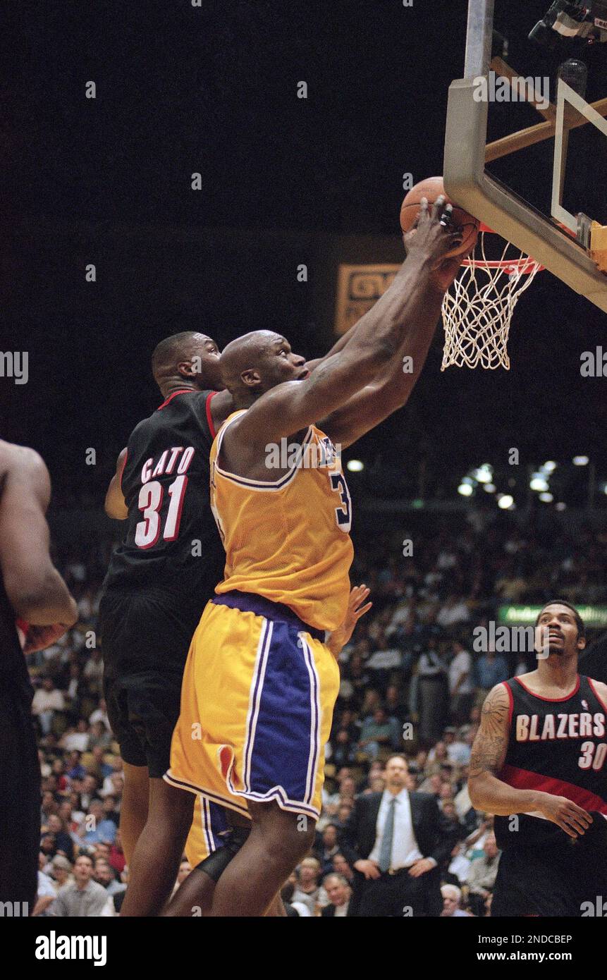 Los Angeles Lakers' Shaquille O'Neal dunks over Portland Trail