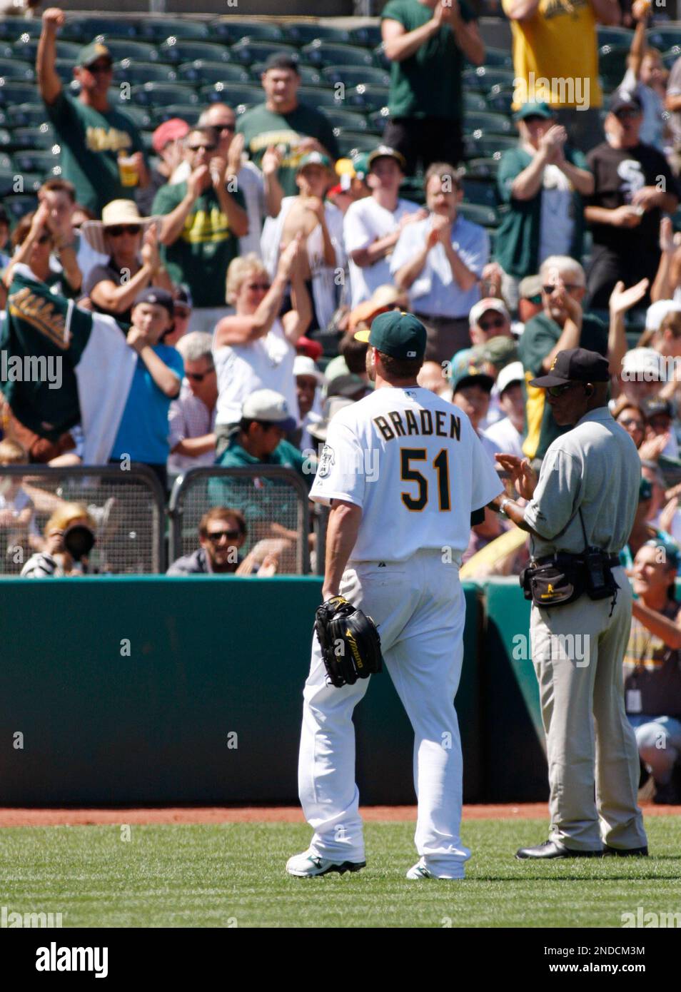 Former Oakland Athletics pitcher Dallas Braden wears a jersey of former San  Francisco Giants pitcher Tim Lincecum before a baseball game between the  Athletics and the Giants in Oakland, Calif., Friday, Aug.