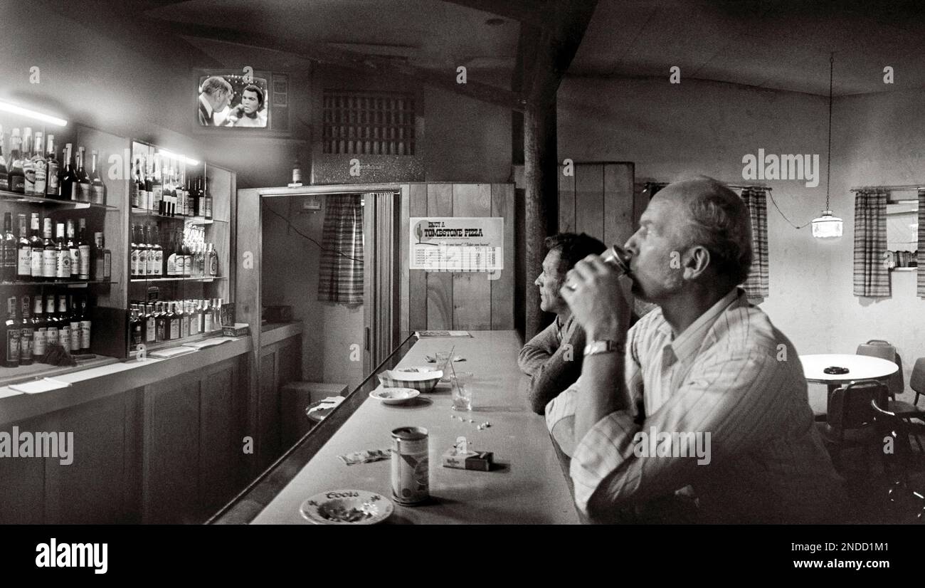 Men at the bar in Sidney, Montana watching Howard Cowell interview boxer Muhammed Ali on TV after Ali’s World Heavyweight Boxing Championship fight Stock Photo