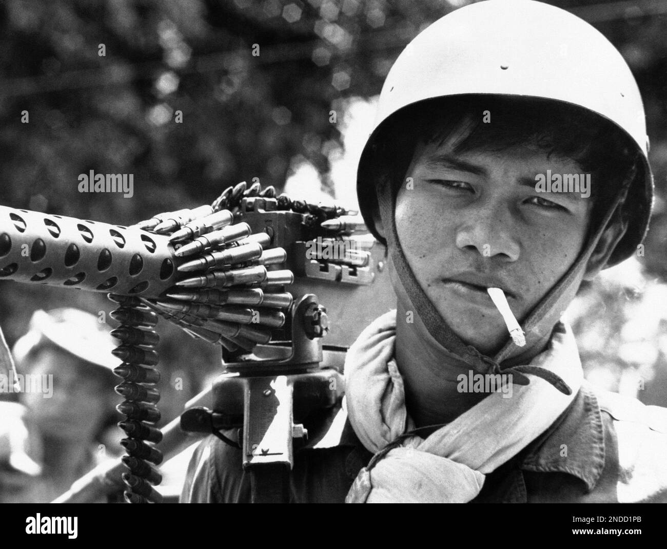A Cambodian soldier carries 30 caliber machine gun, with ammunition ...