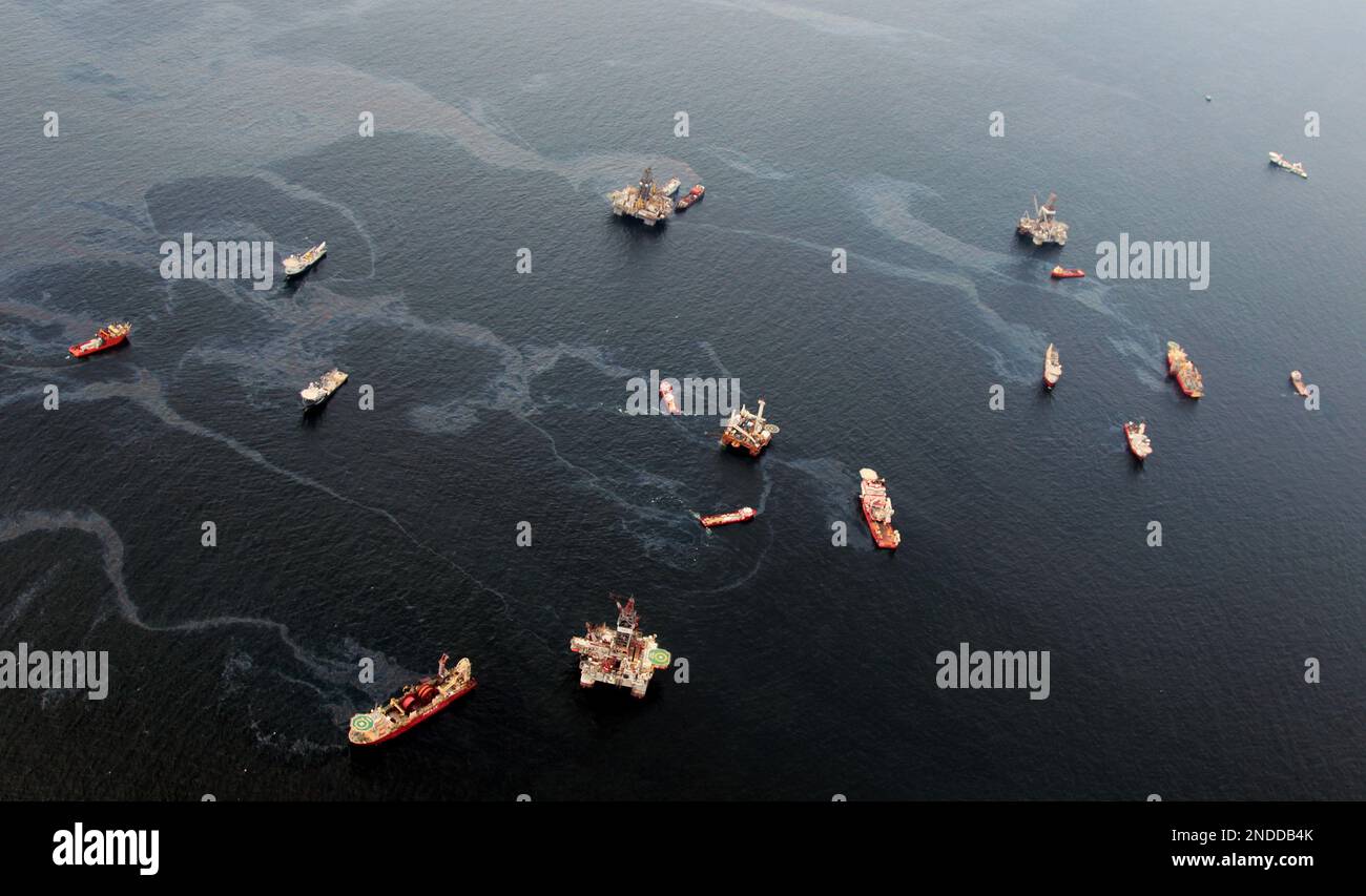 Drilling rigs and workboats operate at the site of the Deepwater ...