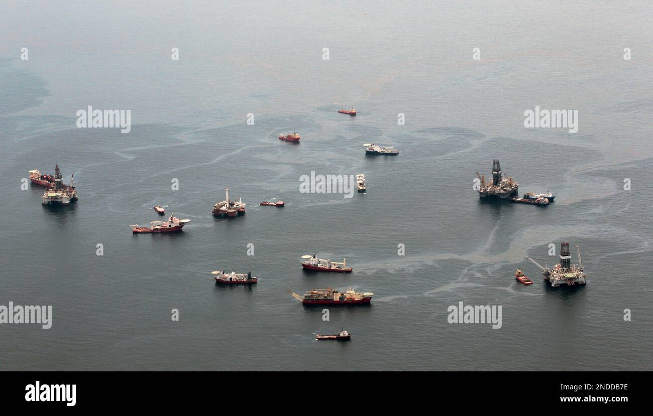 Drilling rigs and workboats operate at the site of the Deepwater ...
