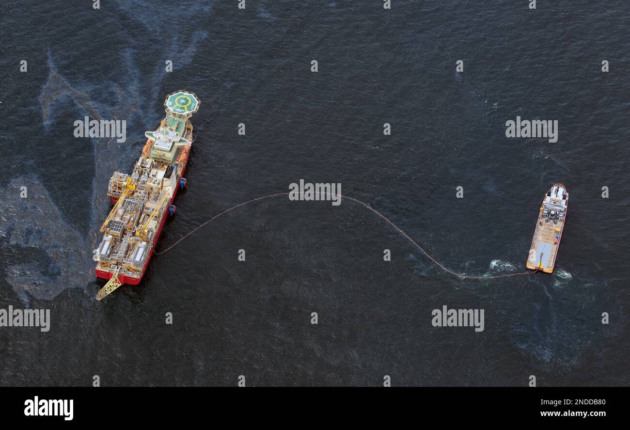 Drilling rigs and workboats operate at the site of the Deepwater ...
