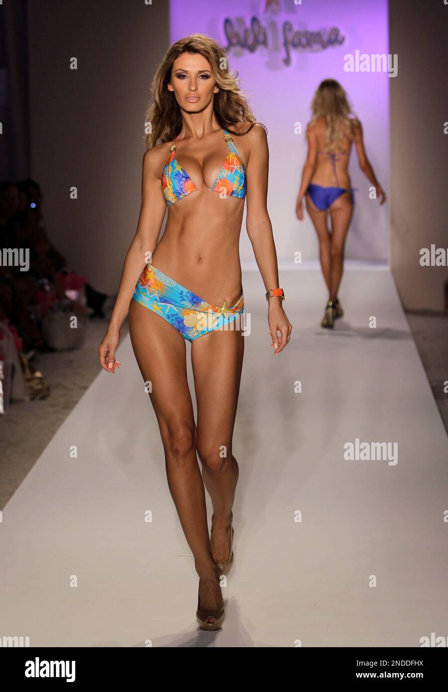 A model walks down the runway during the Luli Fama show at the  Mercedes-Benz Fashion Week Swim 2011 in Miami Beach, Fla. Sunday, July 18,  2010. (AP Photo/Lynne Sladky Stock Photo - Alamy