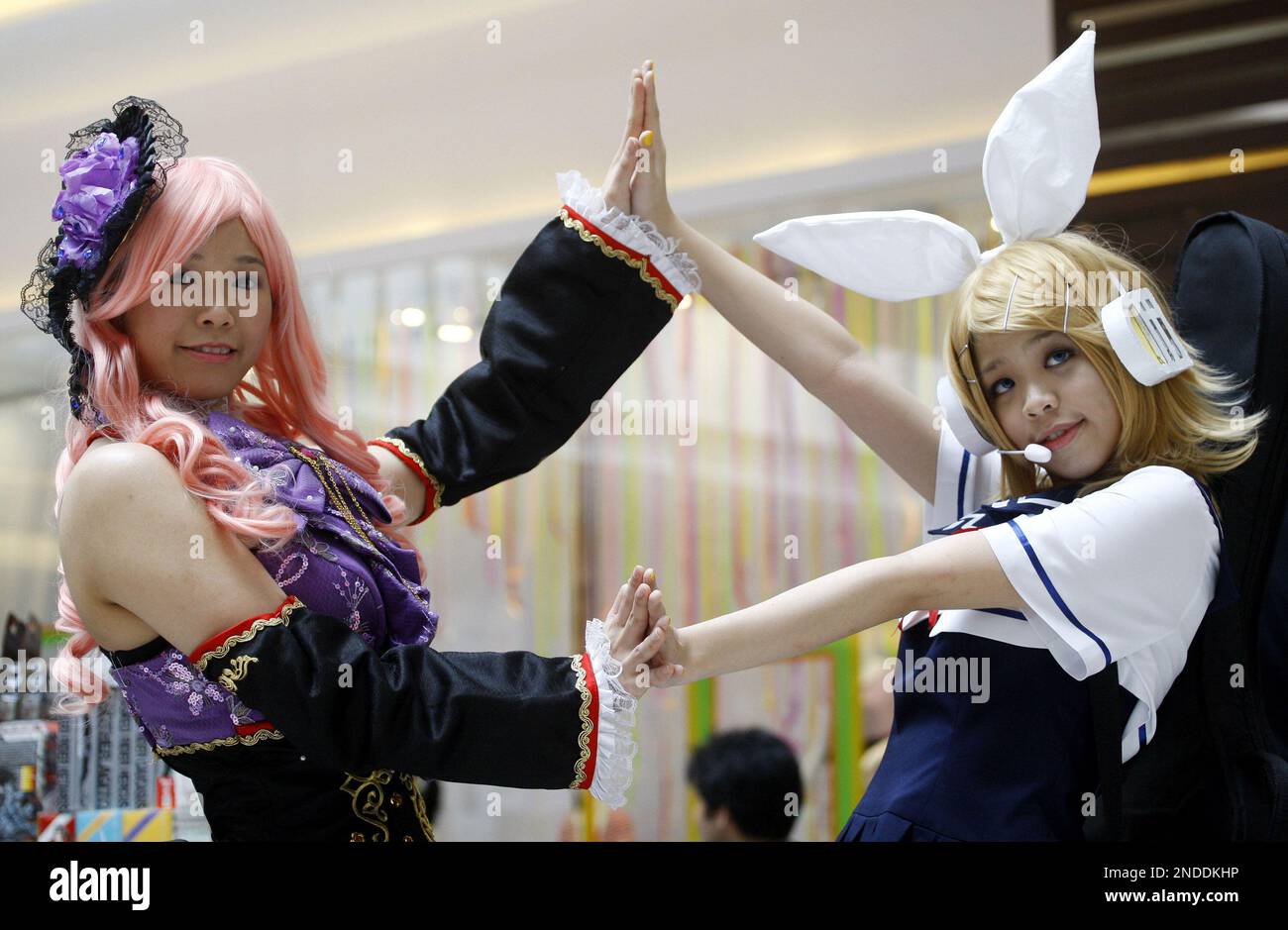 Fans of "cosplay" dressed up as their favorite anime characters pose during the Cosplay, Comics, Anime & Games Exhibition (C2AGE) at a shopping mall in Petaling Jaya, near Kuala Lumpur, Malaysia, Saturday, July 17, 2010. The exhibition aims to introduce the enticing world of Japanese animation, American comics and those with the passion for gaming to youth and the public. (AP Photo/Lai Seng Sin) Stock Photo