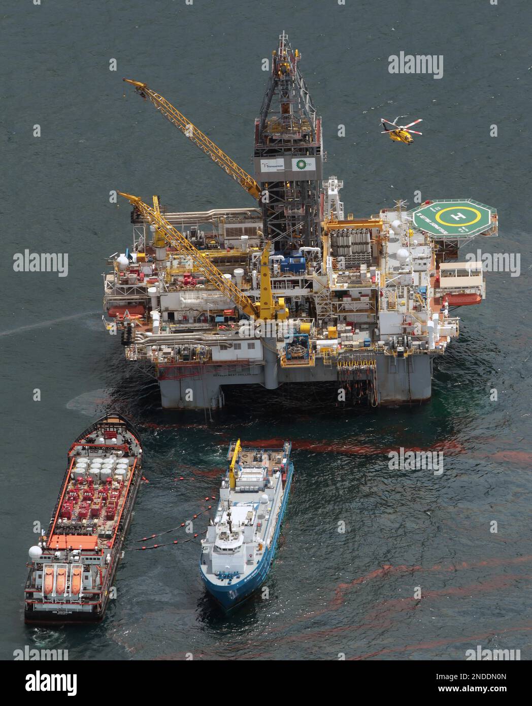 A helicopter lands on the Transocean Development Drilling Rig II at the ...