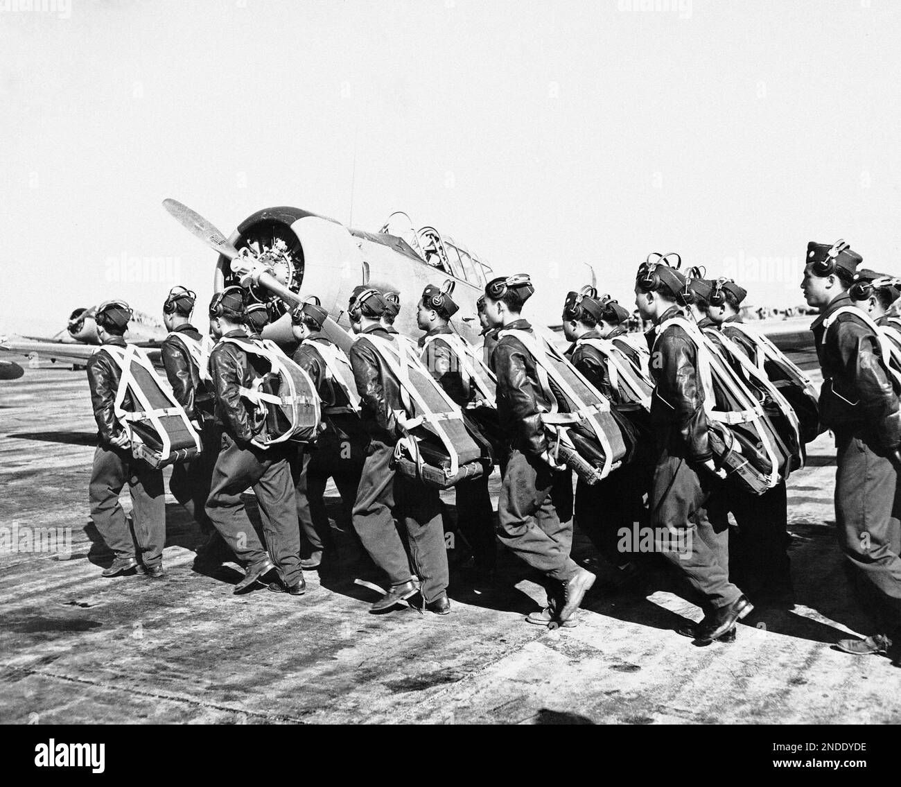 Equipped with parachutes, a squad of Chinese air cadets marches to the ...