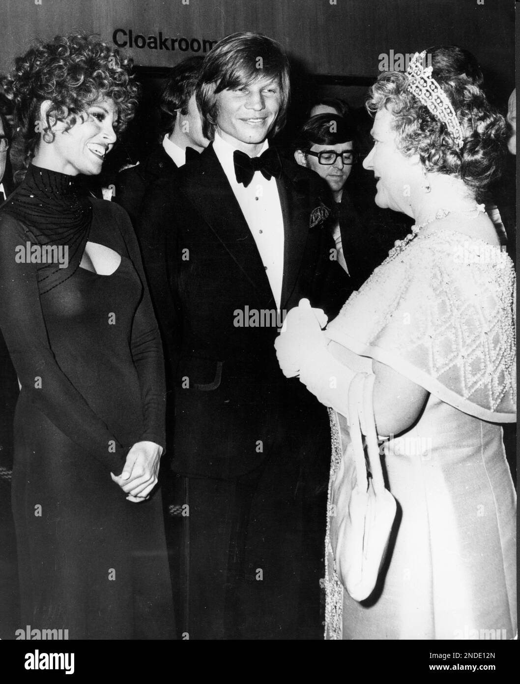 1974, London, England, United Kingdom: The QUEEN MOTHER talking to RAQUEL WELCH, one of the stars of The Three Musketeers before the showing of the film at the Royal Film Performance at the Odeon Theatre, Leicester Square. English actor MICHAEL YORK at right. (Credit Image: © Keystone Press Agency/ZUMA Press Wire) EDITORIAL USAGE ONLY! Not for Commercial USAGE! Stock Photo