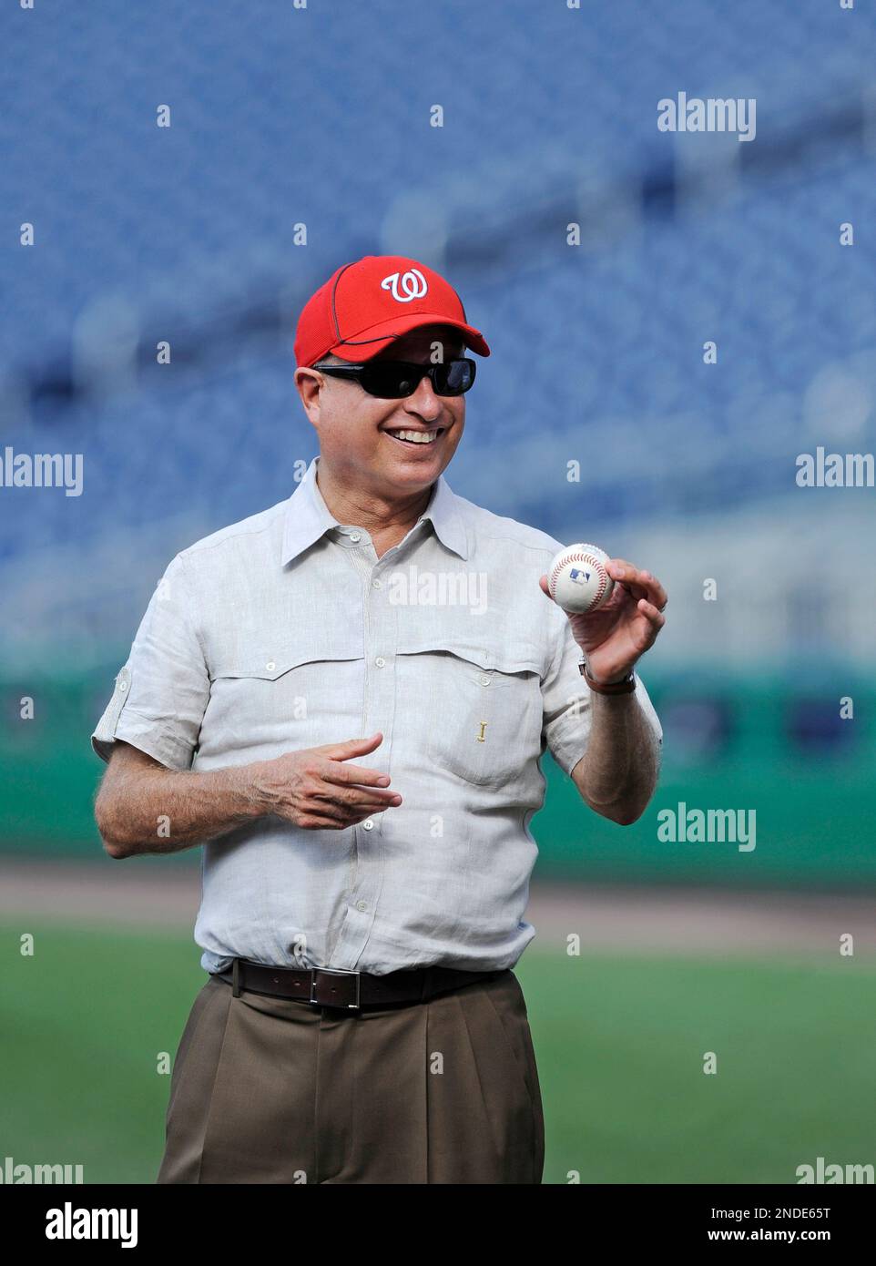 From left, Washington Nationals principal owner Mark Lerner, speaks with  Washington Commanders team owner Josh Harris and his son Stuart and wife  Marjorie before Harris throws out the ceremonial first pitch before