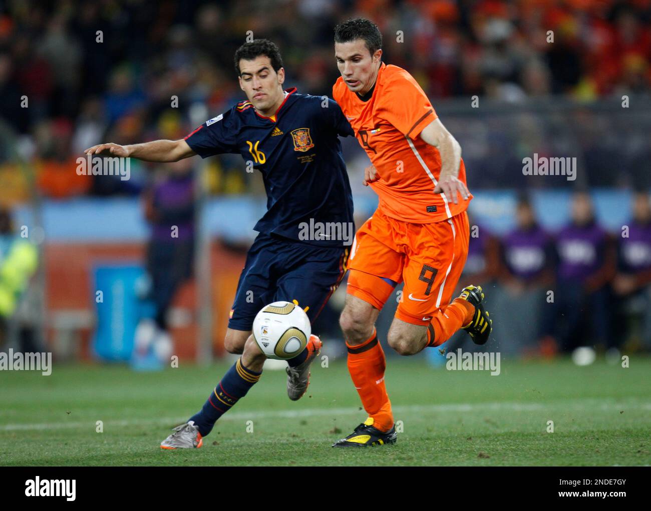 Spain's Sergio Busquets, left, Netherlands' Robin van Persie during the World Cup final soccer