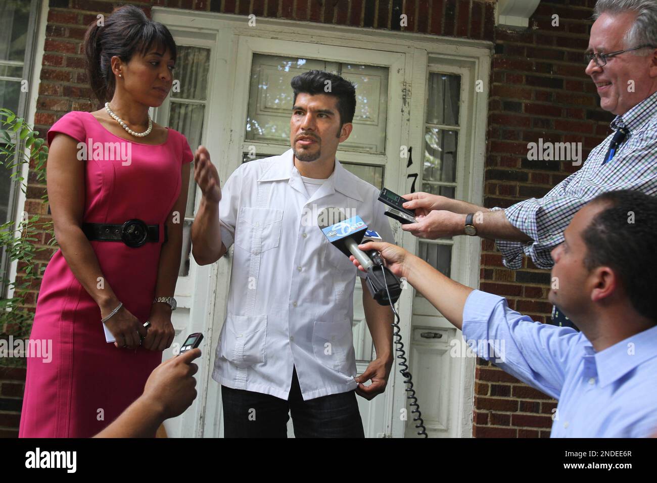 Waldo Mariscal, center, son of accused spy Vicky Pelaez, speaks to the media with his attorney Genesis Peduto, left, on the front porch of his family home in Yonkers, N.Y., Friday, July 9, 2010. (AP Photo/Seth Wenig) Stock Photo