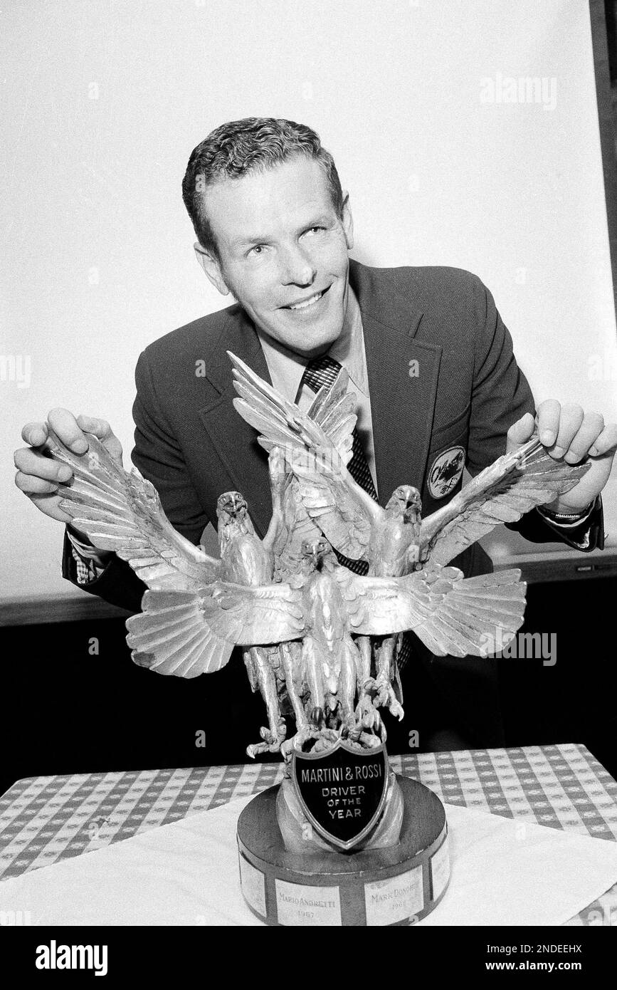 Race car driver Bobby Unser of Albuquerque, N.M., shows off the trophy