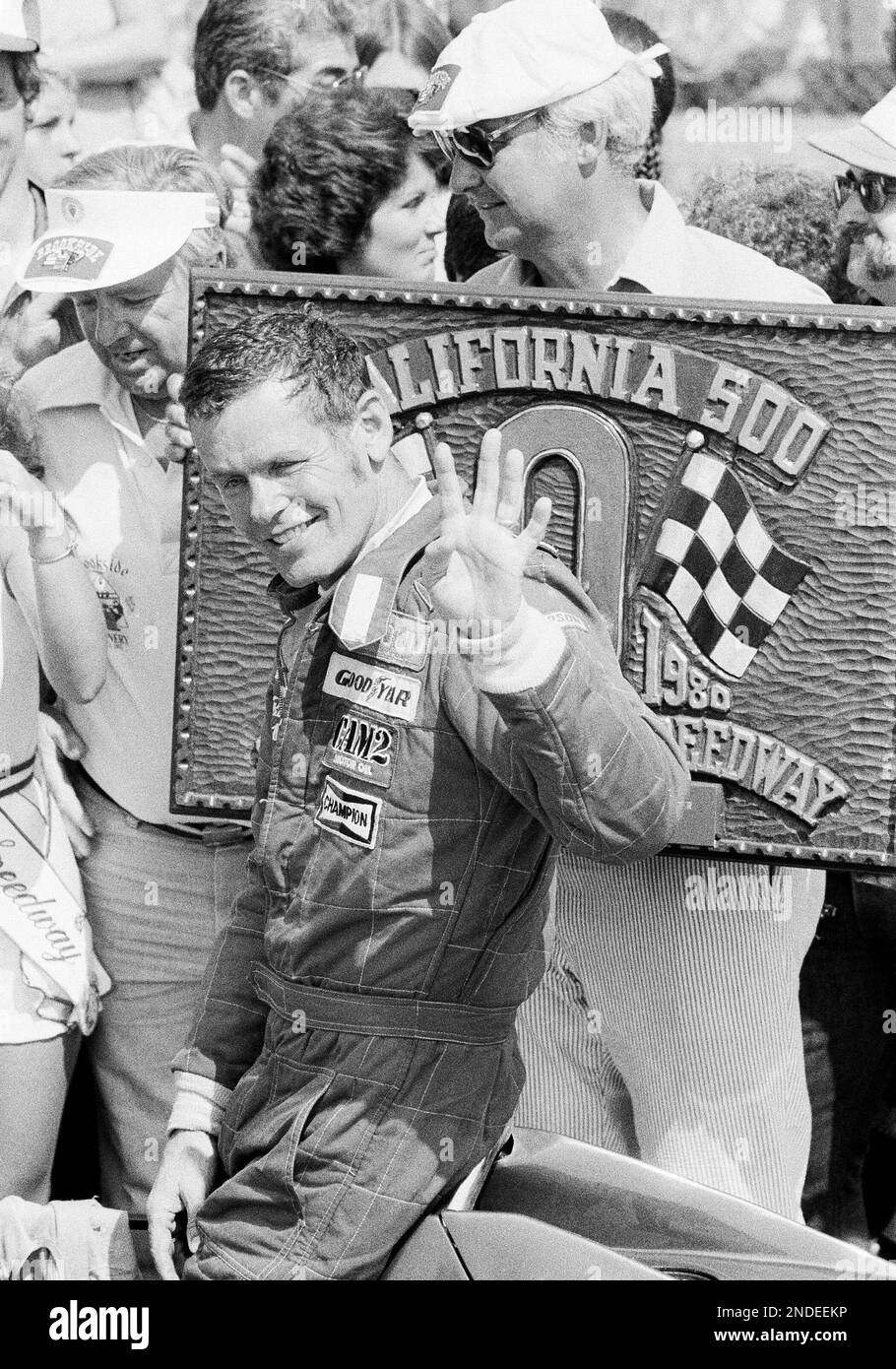 Bobby Unser holds up four fingers after winning his fourth California