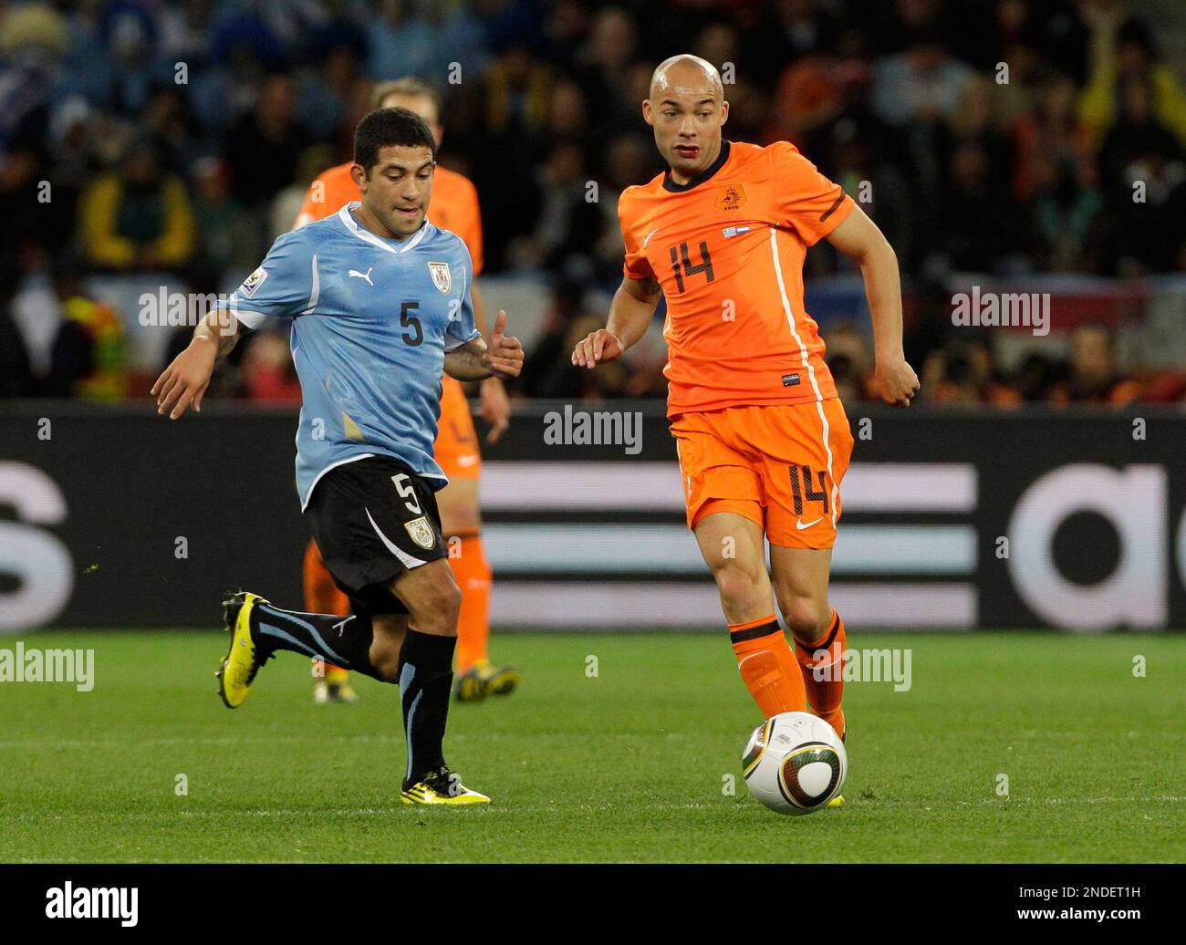 Netherlands' Demy de Zeeuw, right, Uruguay's Walter Gargano during the  World Cup semifinal soccer match between Uruguay and the Netherlands at the  Green Point stadium in Cape Town, South Africa, Tuesday, July