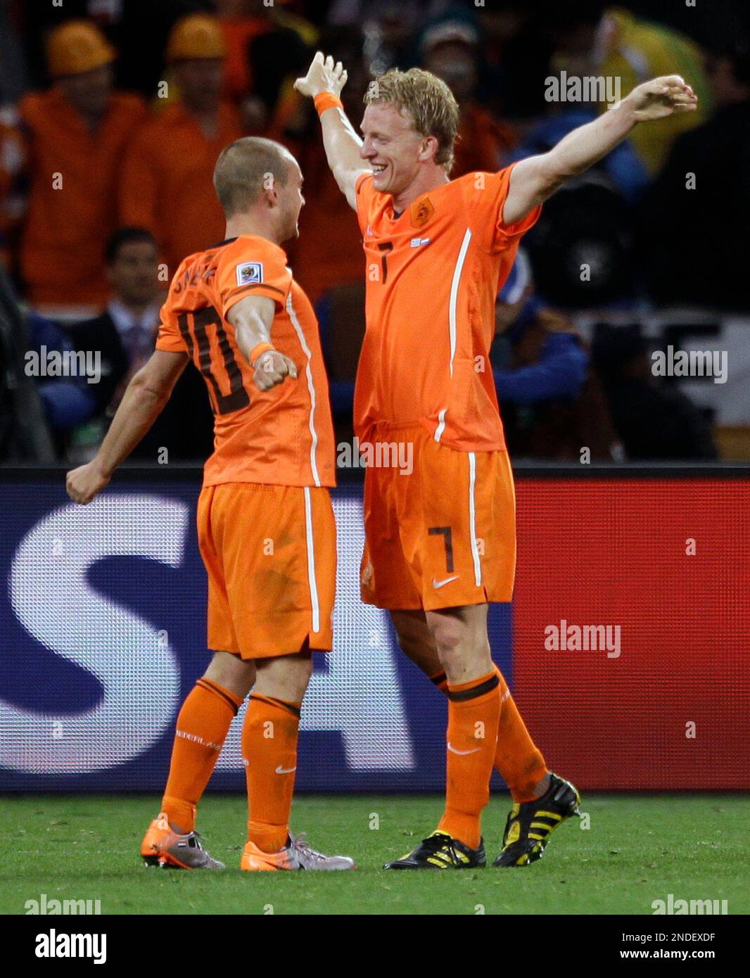 Netherlands' Wesley Sneijder, left, celebrates with teammate Dirk Kuyt