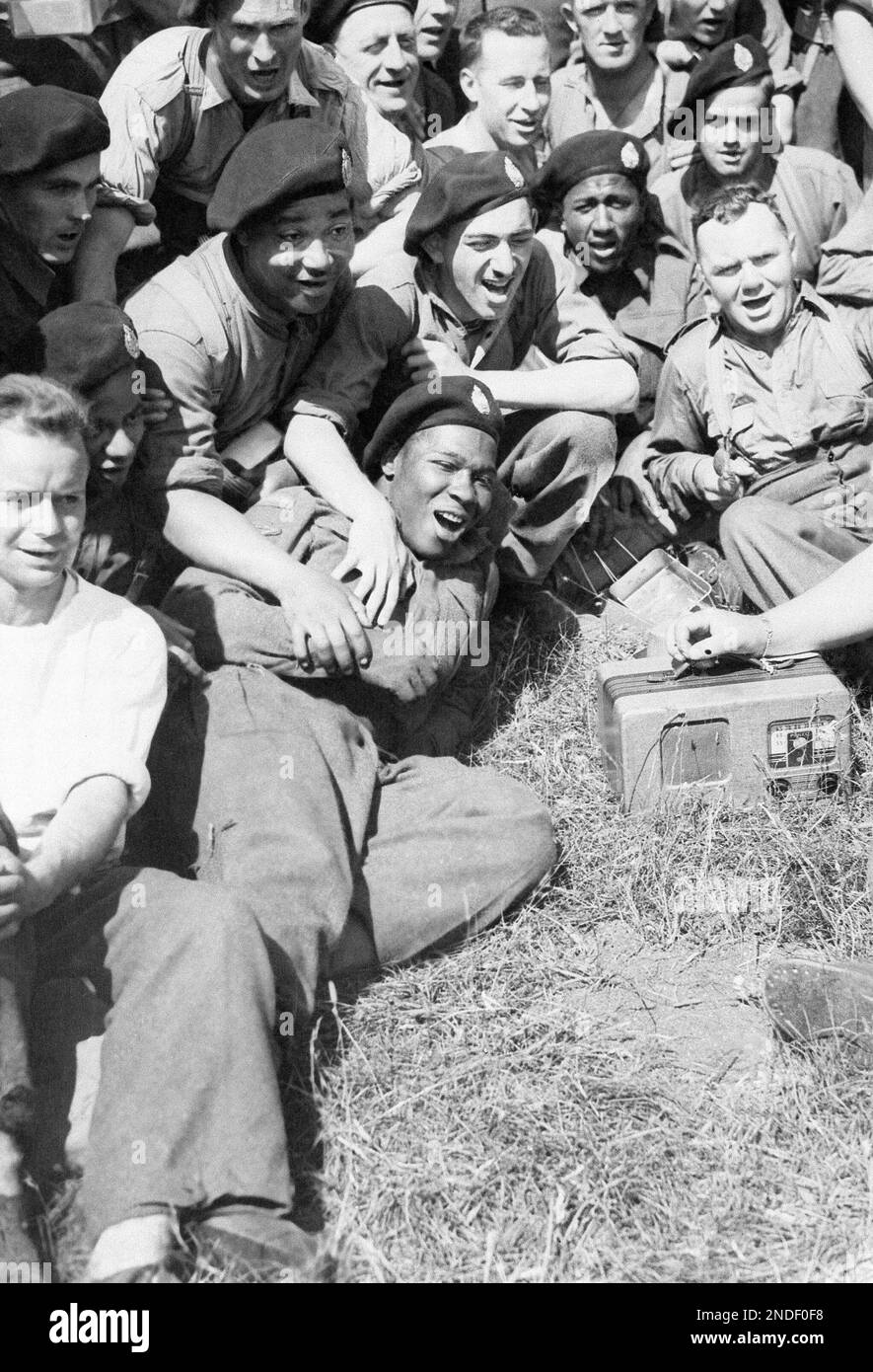 A portable radio helps these Canadian Tank Corps troopers give out in