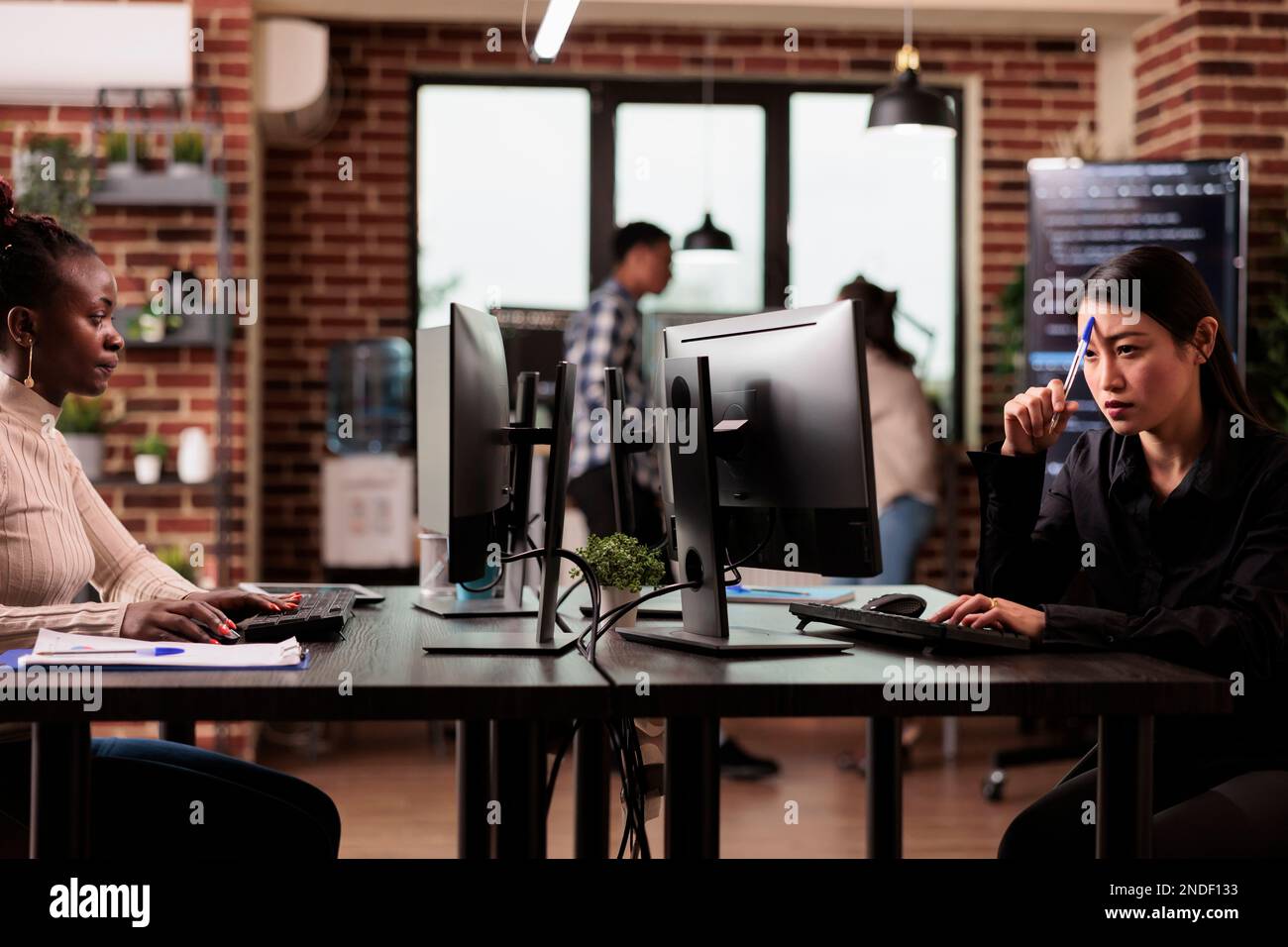 Pensive asian tech programmer working on code development and ...