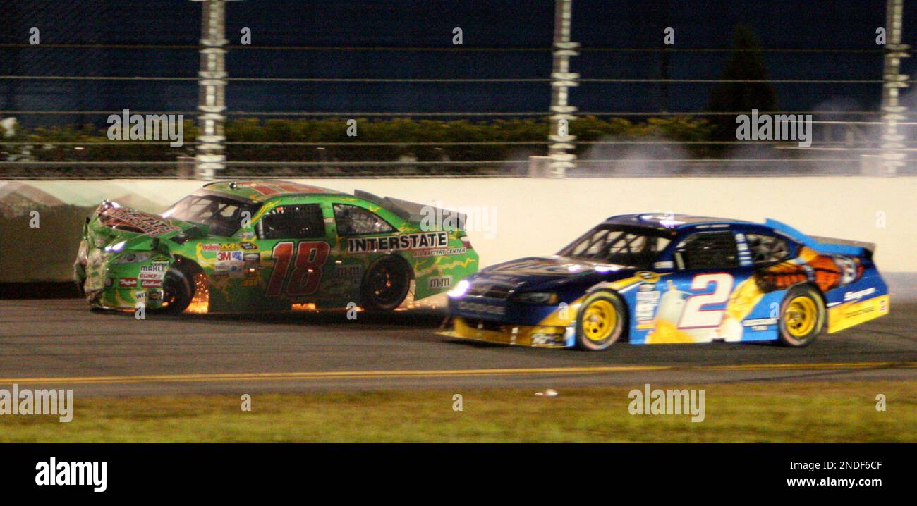 NASCAR driver Kyle Busch (18) hits the wall on the back stretch as