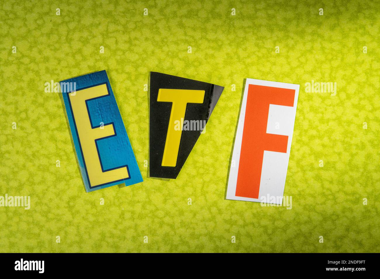 The acronym 'ETF'  (exchange-traded fund) using cut-out paper letters in the ransom note effect typography, USA Stock Photo