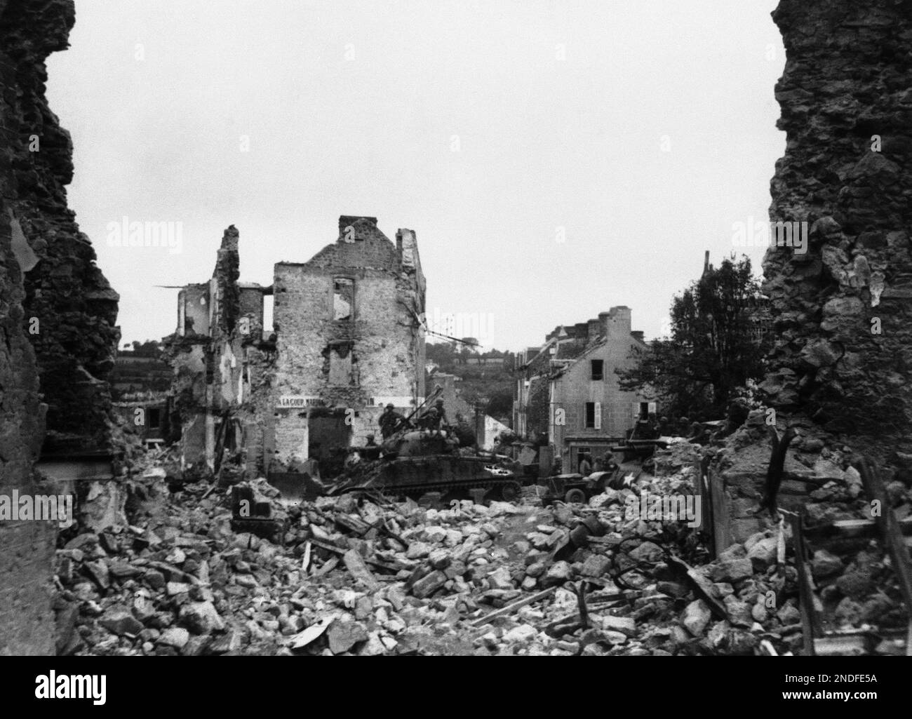 American tanks and armour rumbling through one of the wrecked streets ...