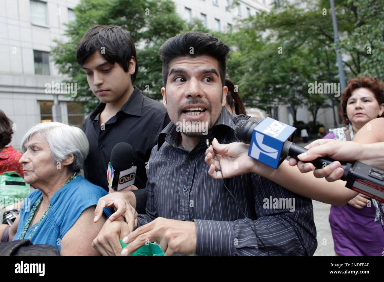 Vicky Pelaez sons Waldo Mariscal, foreground, and Juan Jose Lazaro are surrounded by reporters as the leave Manhattan Federal Court Thursday, July 1, 2010 in New York. (AP Photo/Mary Altaffer) Stock Photo