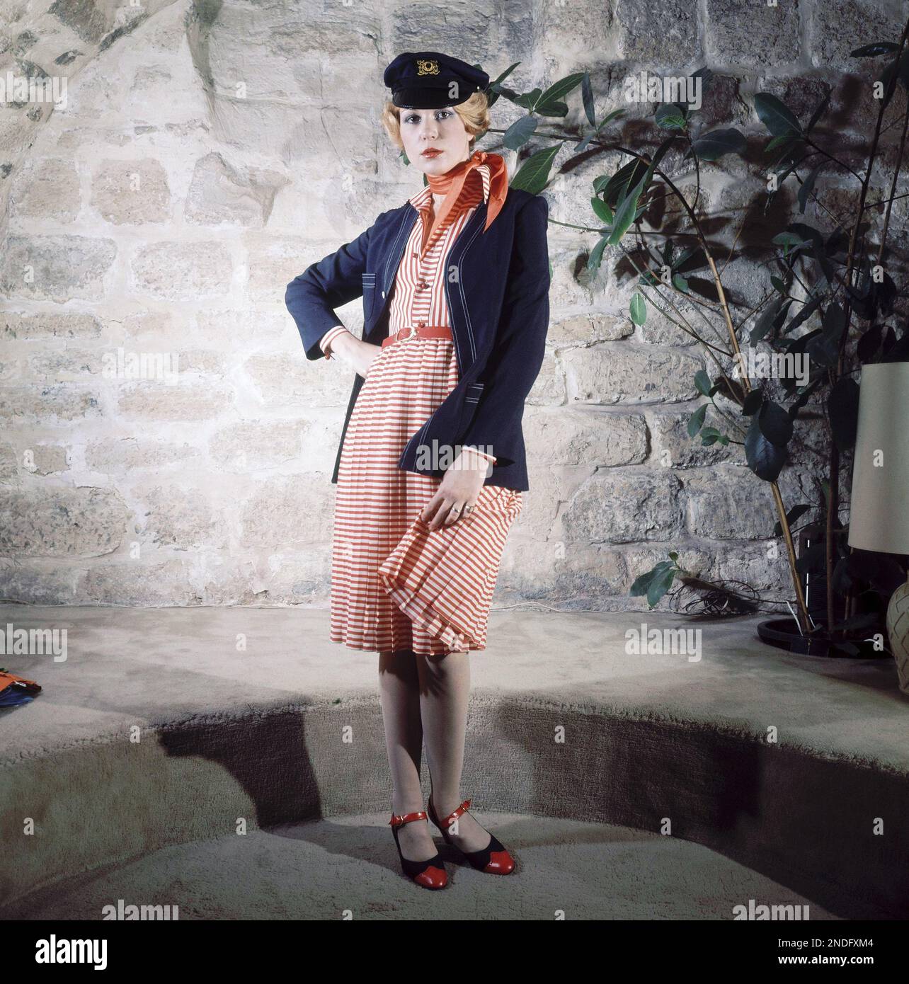 Fashion designer Louis Feraud presents in his Spring-Summer 74 collection  this dress, Jan. 22, 1974: holiday dream' red and white navy styled dress,  pleated. Marine alpaga blazer, bicolored shoes and sailor cap. (