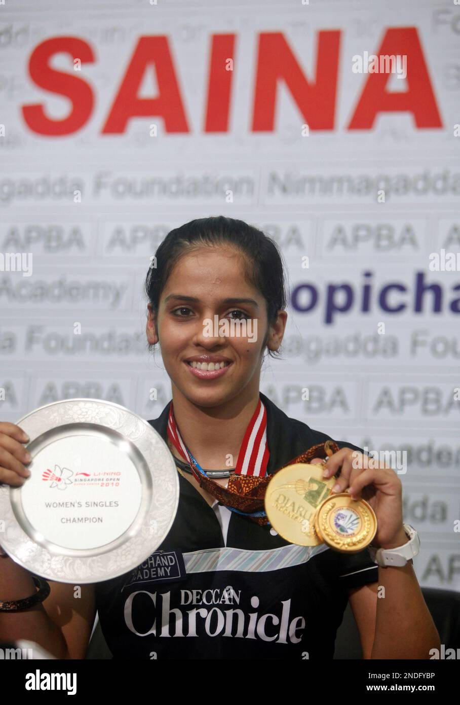 Indian badminton player Saina Nehwal displays her medals during a press conference in Hyderabad, India, Tuesday, June 29, 2010