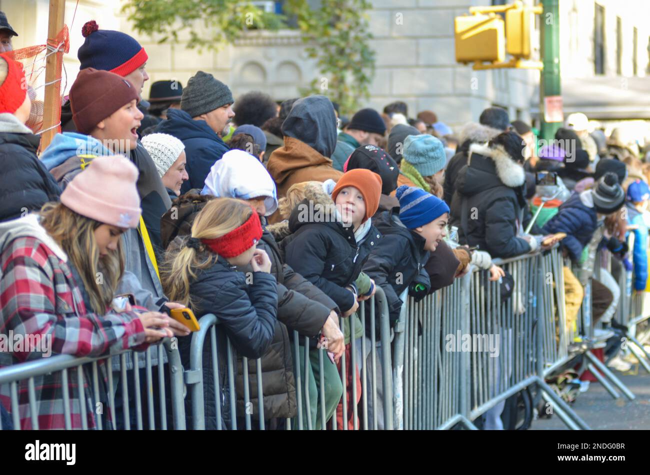 A crowd of people enjoying the Macy's Thanksgiving day parade along ...