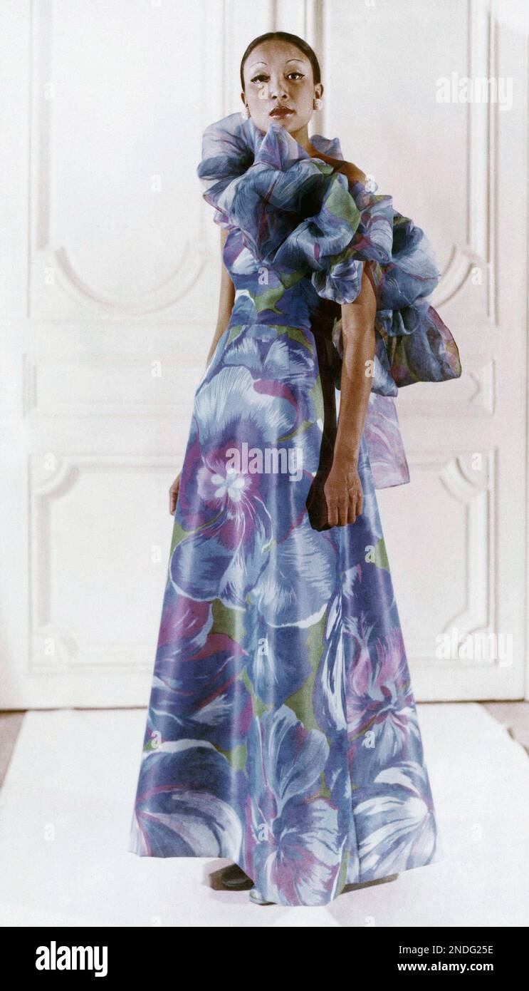 An evening dress in blue silk faille with a bathing suit style dcollet.  Worn with an organza boa of matching material. From the Paris fashion house  of Givenchy in 1973. (AP Photo