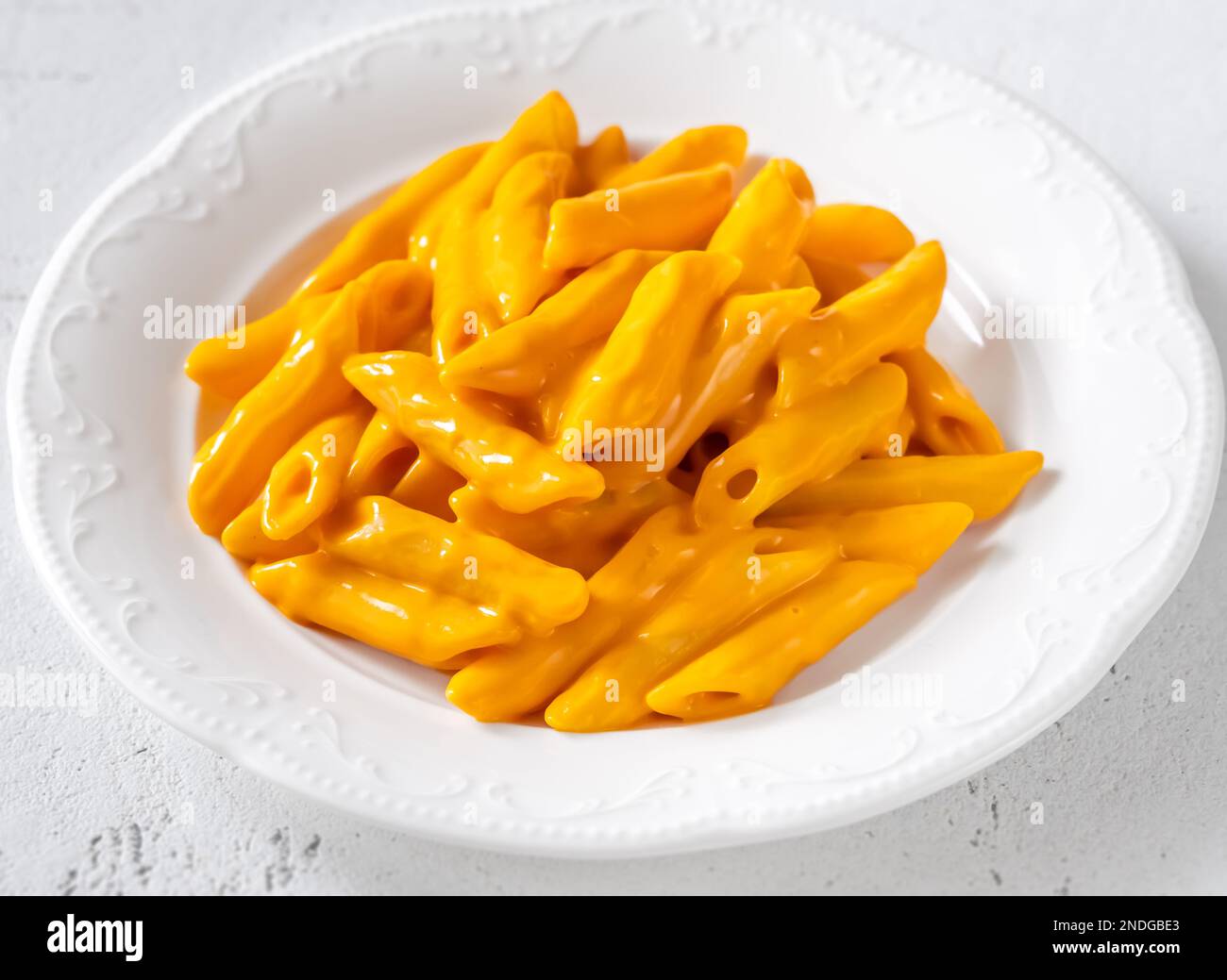 Portion of penne pasta with cheddar sauce Stock Photo Alamy