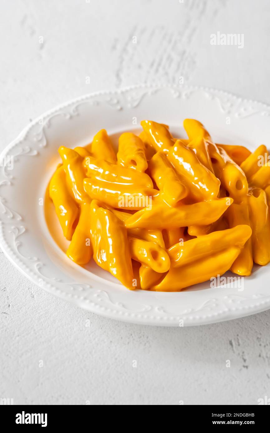 Portion of penne pasta with cheddar sauce Stock Photo Alamy