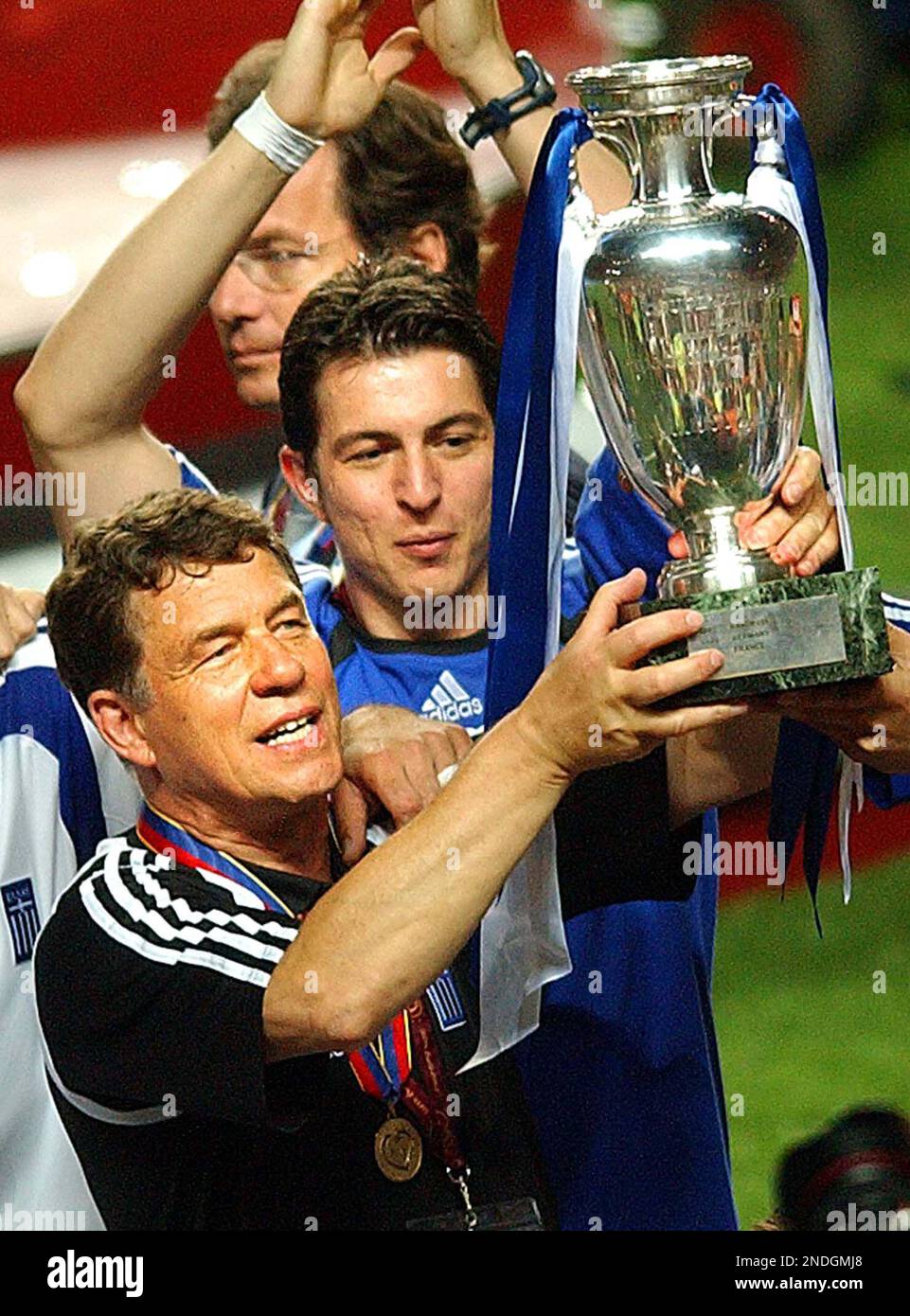 FILE - In this july 4, 2004 file picture Greece coach Otto Rehhagel holds  the trophy as he celebrates with his players after beating Portugal 1-0 in  the Euro 2004 soccer championship