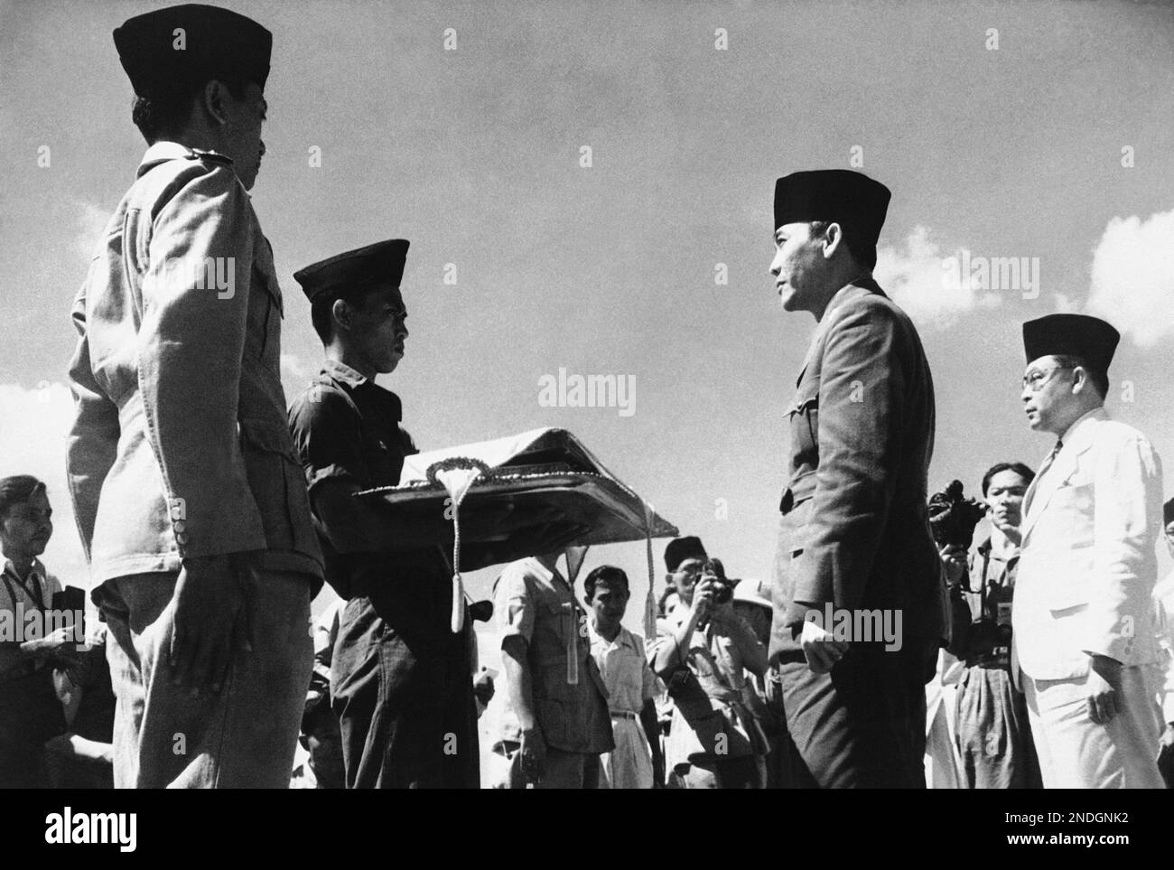 President Sukarno of Indonesia, second right, hands the red and white
