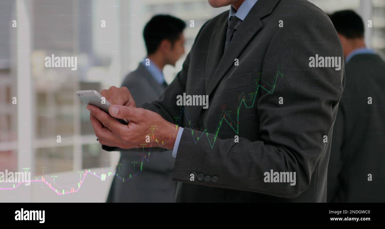 Composition of financial data processing over caucasian businessman using smartphone Stock Photo