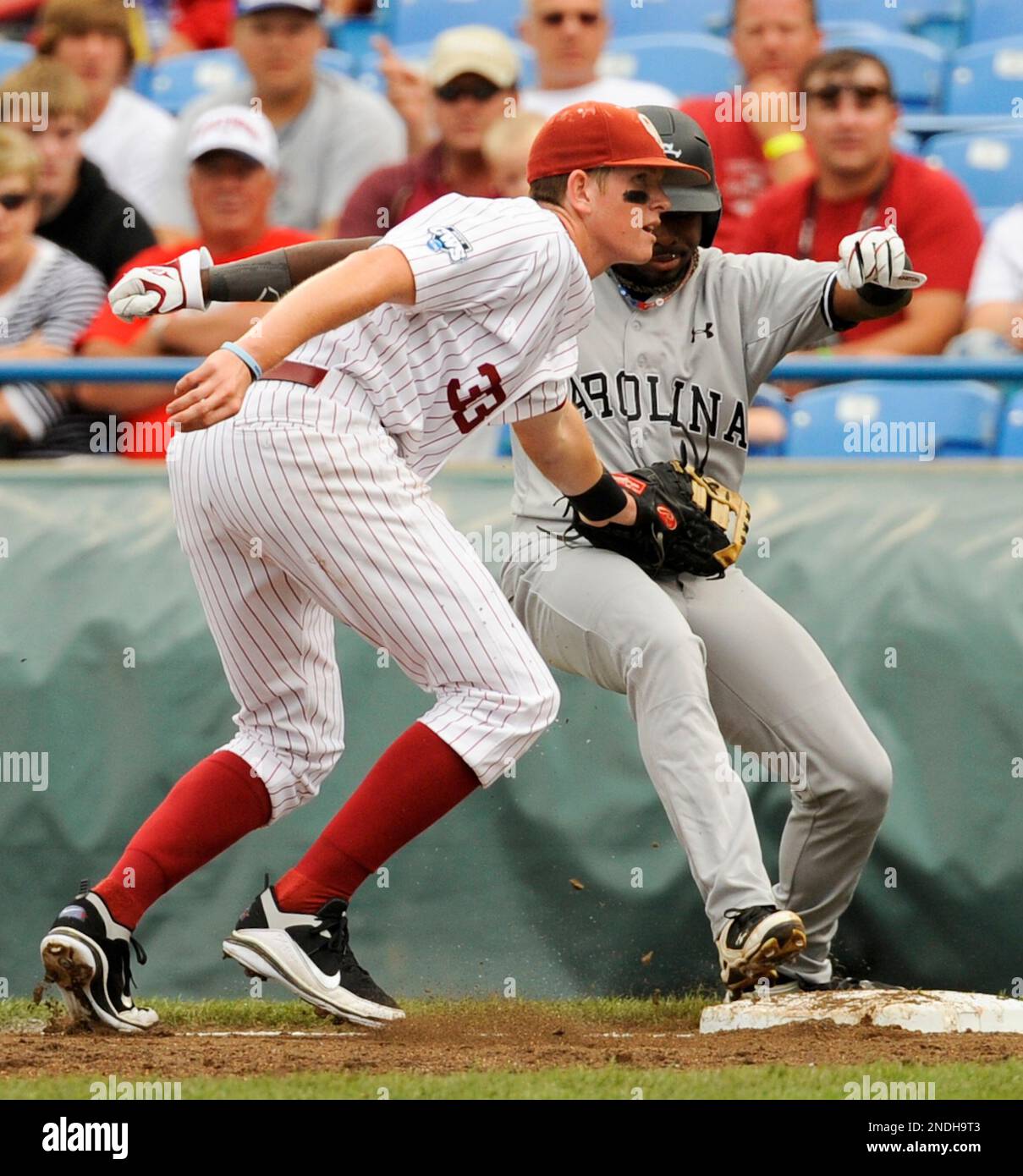 South Carolina's Scott Wingo, left, exchanges high fives with teammate Jackie  Bradley, Jr., after Wingo scored against Texas A&M on a throwing error in  the first inning of an NCAA College World