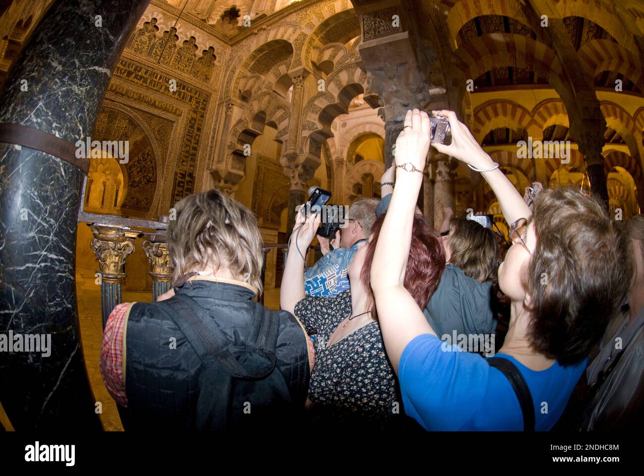 Tourists taking photos at etrance to the Mihrab (shrine of Byzantine mozaics), Mezquita (Mosque) inside the Cathedral, Mosque–Cathedral of Córdoba, Có Stock Photo