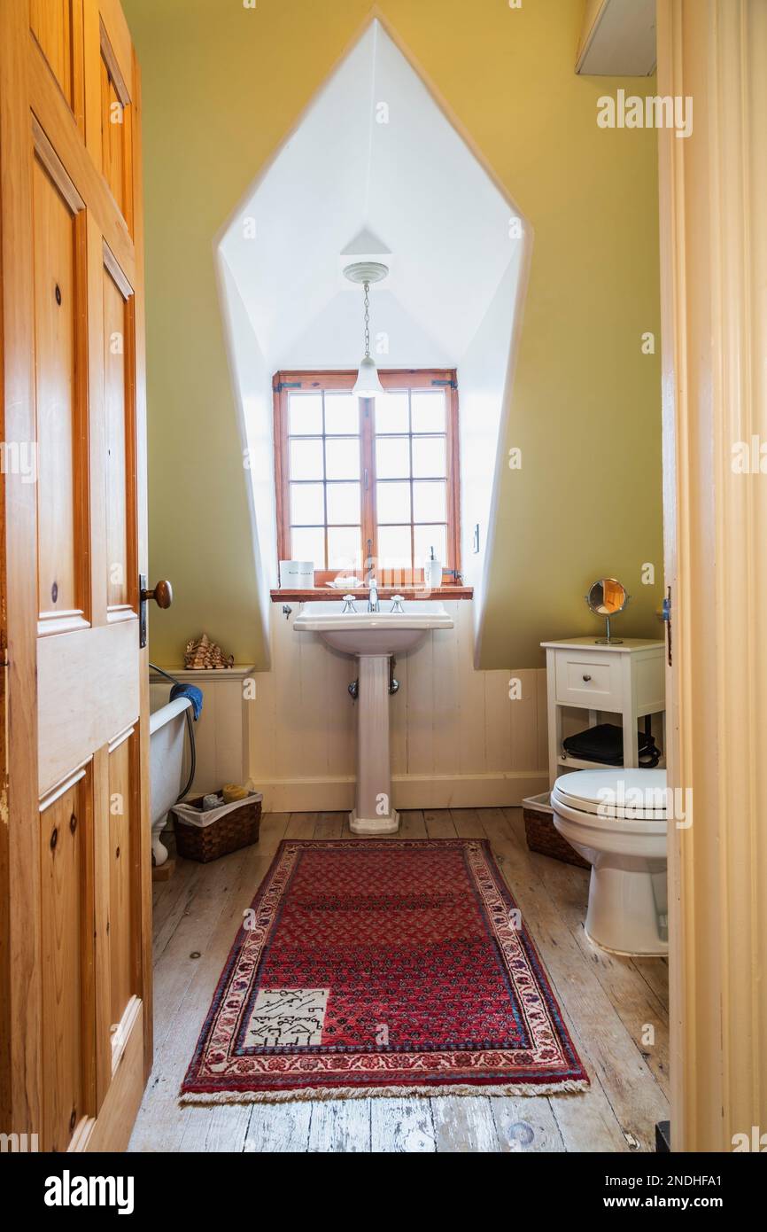 Freestanding roll top bathtub, pedestal sink and toilet in upstairs