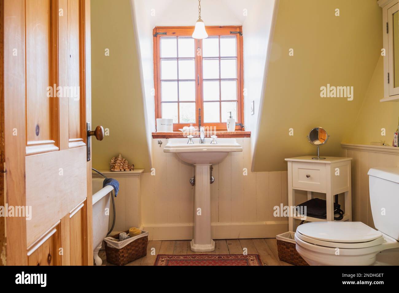 Freestanding roll top bathtub, pedestal sink and toilet in upstairs
