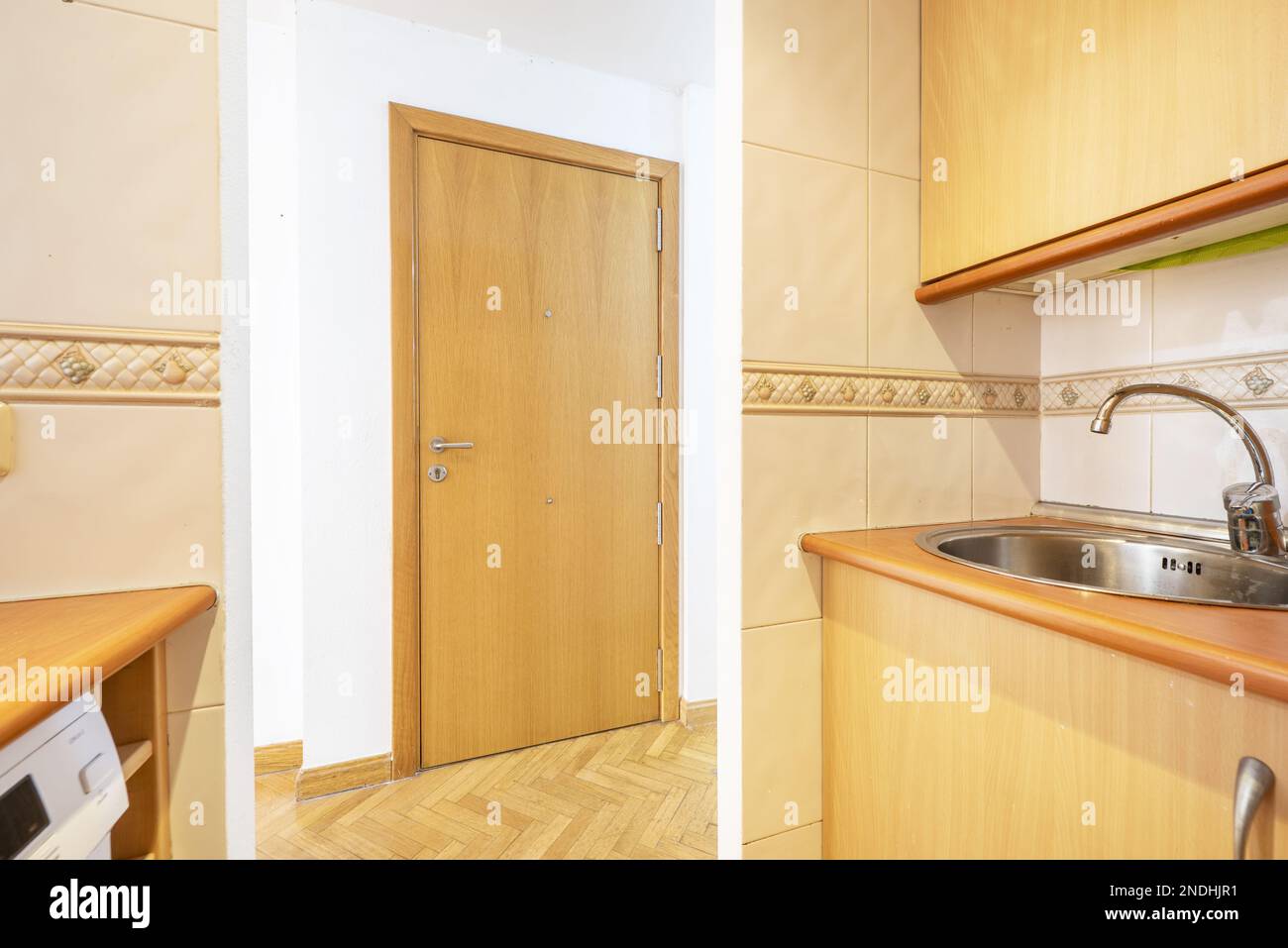 Small kitchen with light wood with steel and wood accents on