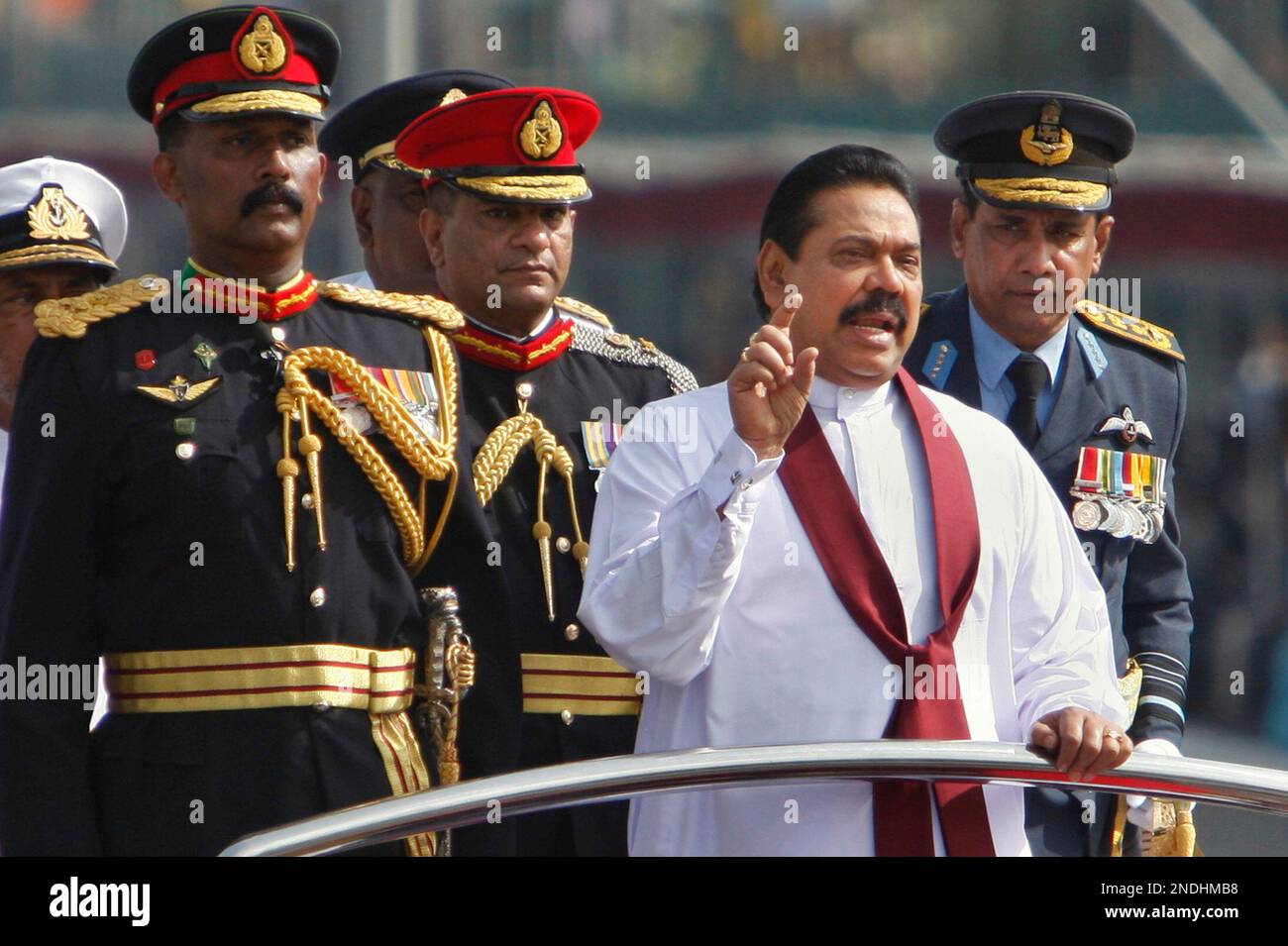 Sri Lankan President Mahinda Rajapaksa gestures from atop a jeep as ...