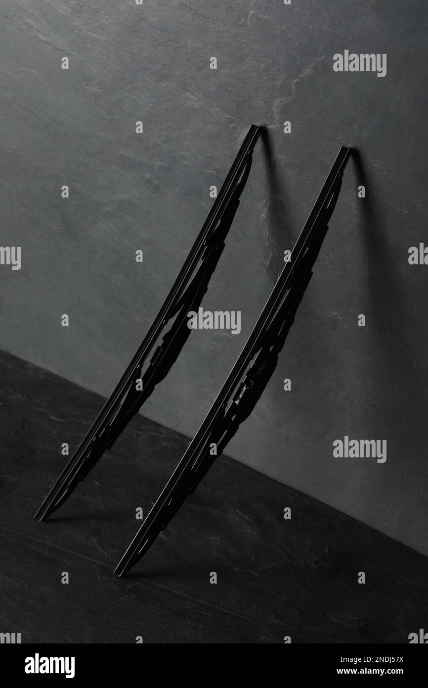 Car windshield wipers on black slate table Stock Photo - Alamy