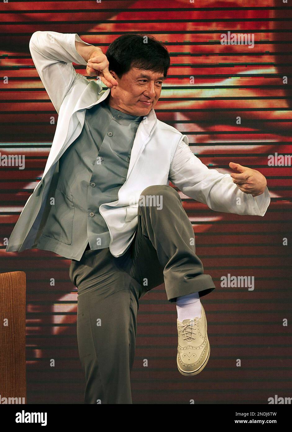 Hong Kong actor Jackie Chan performs martial arts on a stage while
