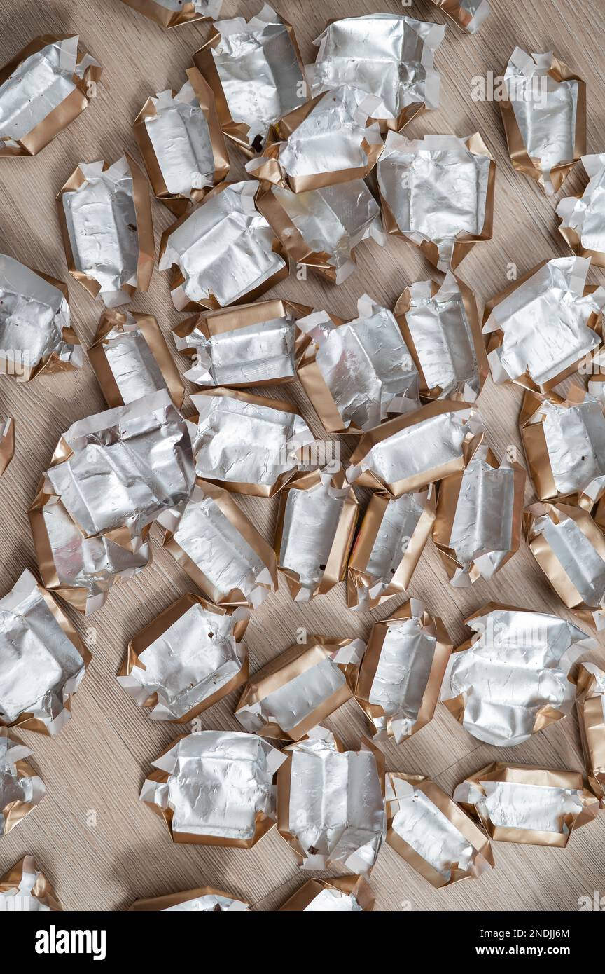 Pile of empty silvergold candy wrappers. Top view Stock Photo Alamy