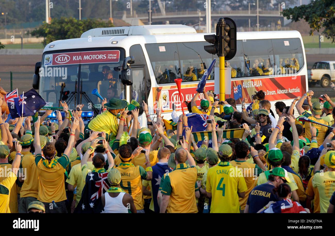 Australian soccer fans cheer as the bus of the Australian soccer team
