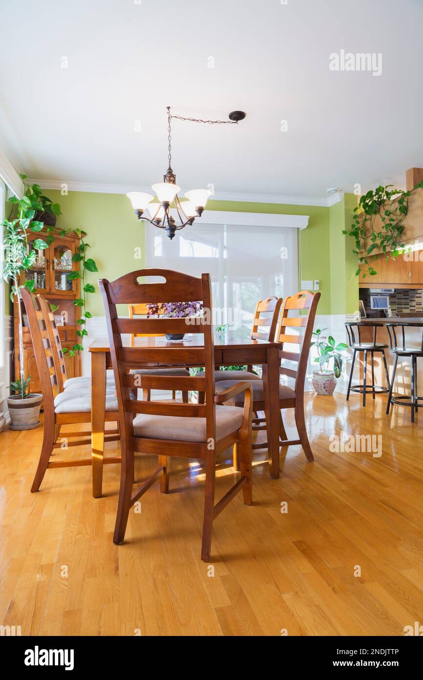 Ash wood table and chairs in dining room with oak wood floorboards