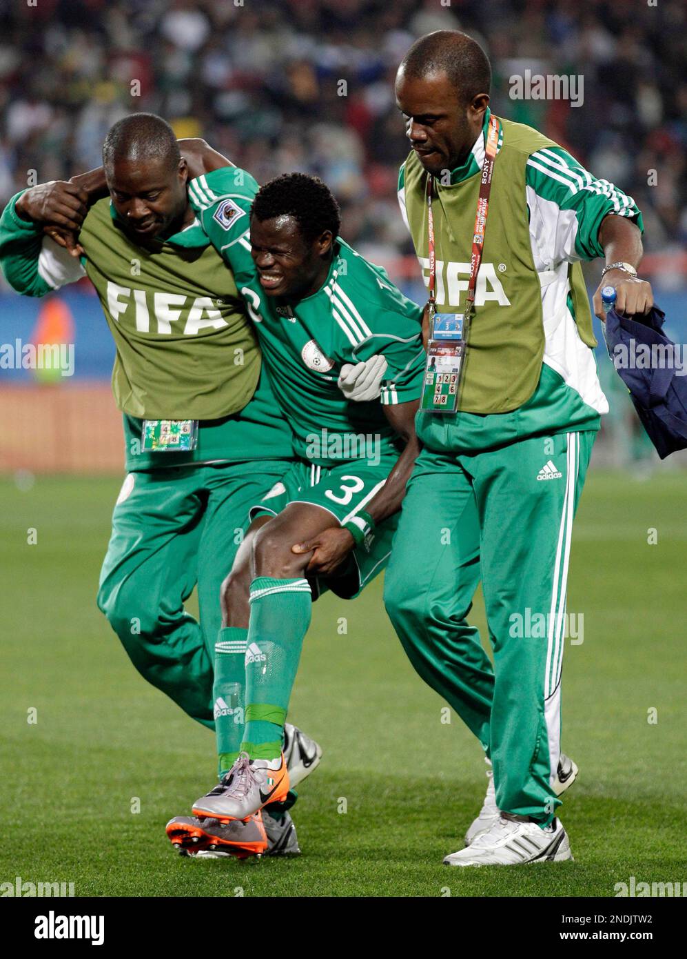 Nigeria's Taye Taiwo is helped out of the pitch during the World Cup ...
