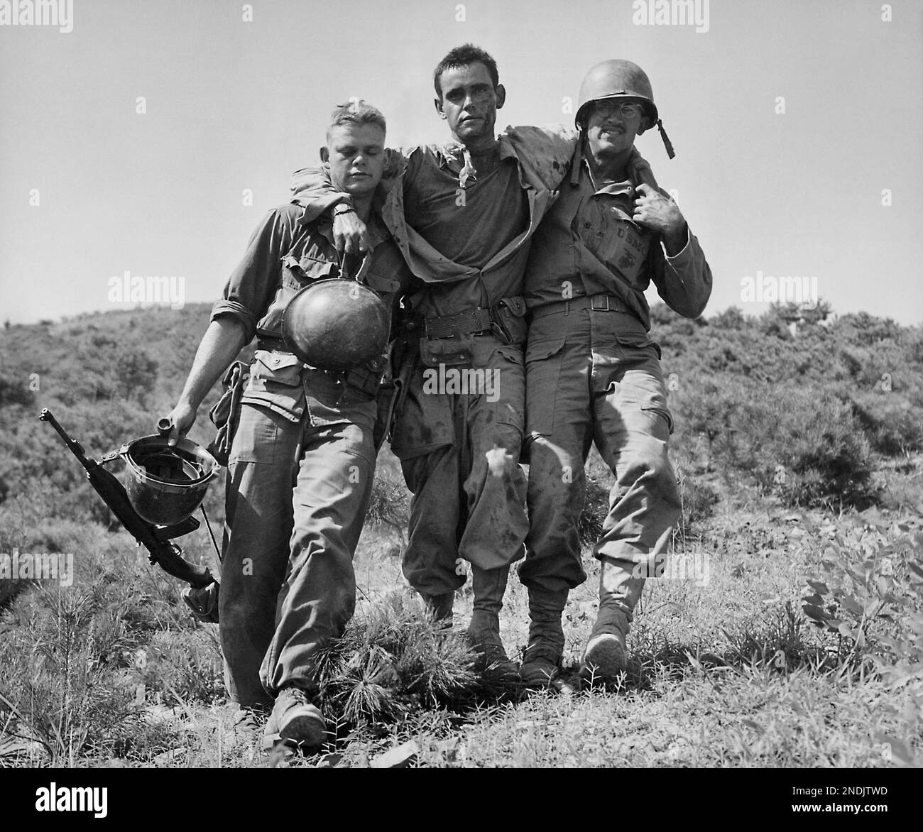 FILE - In August 1950 file photo, U.S. Marines help a wounded buddy on ...