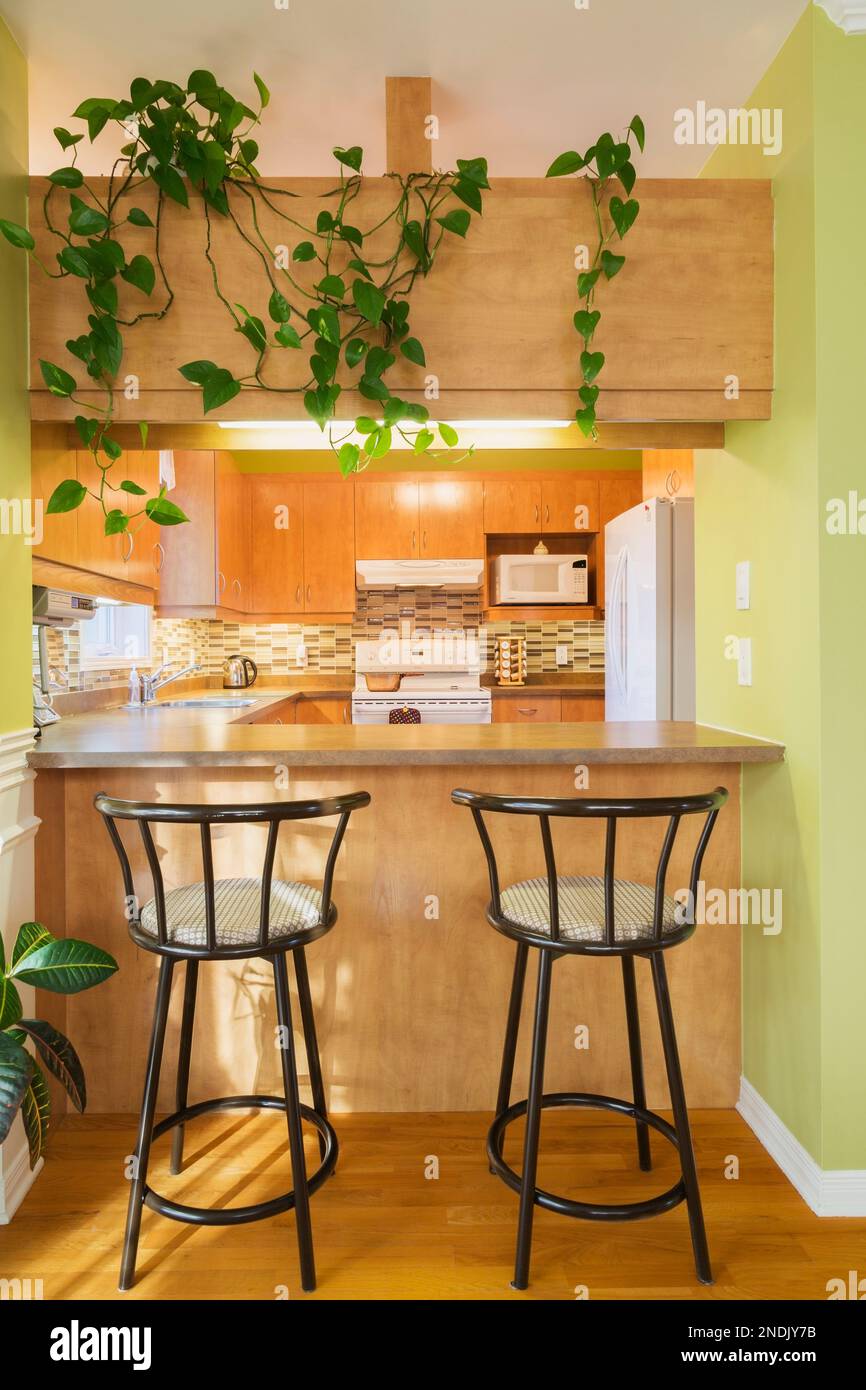 Kitchen counter with bar stools inside country style house Stock Photo