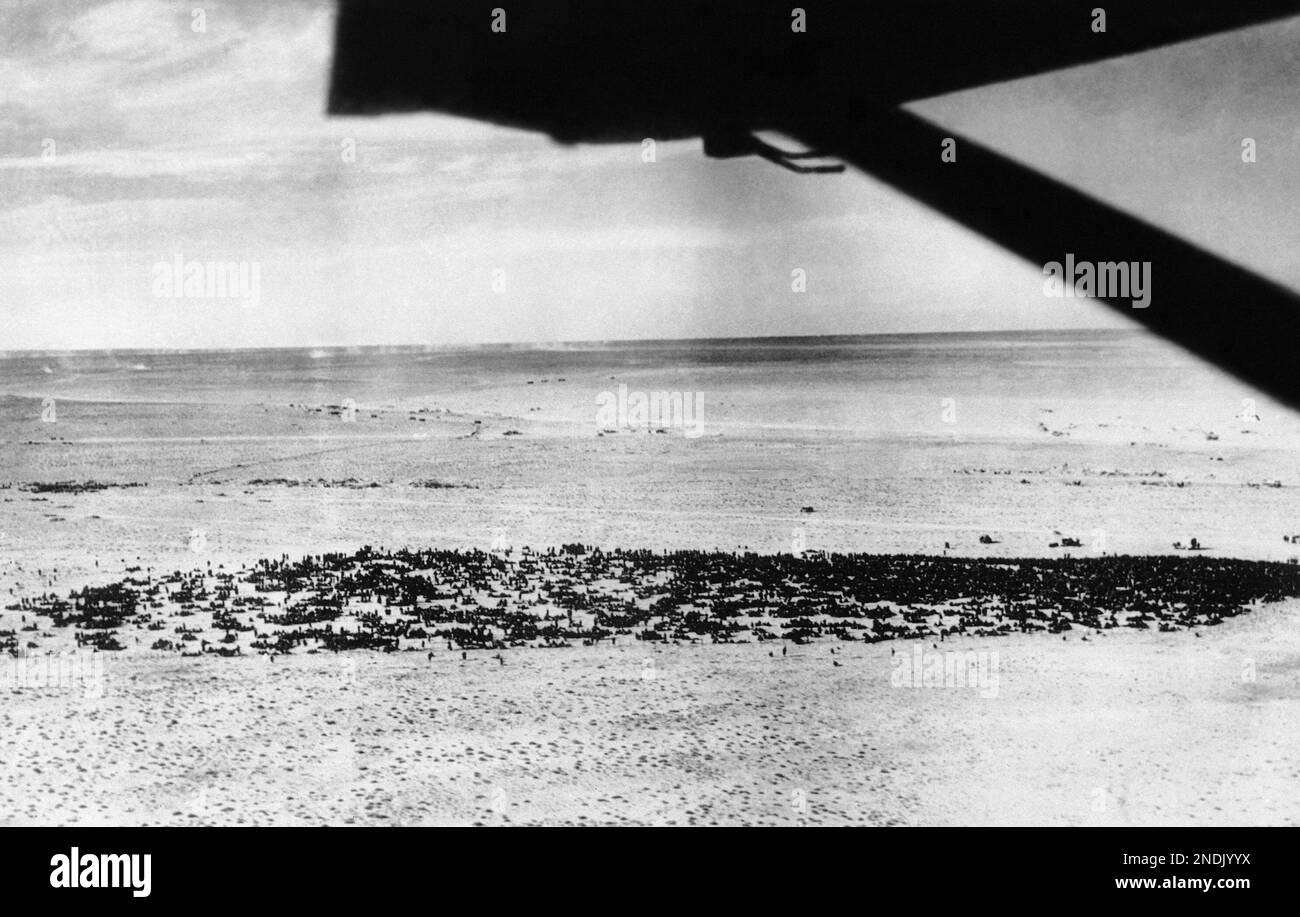 Seen from the air, masses of Italian prisoners wait on the sands Feb ...